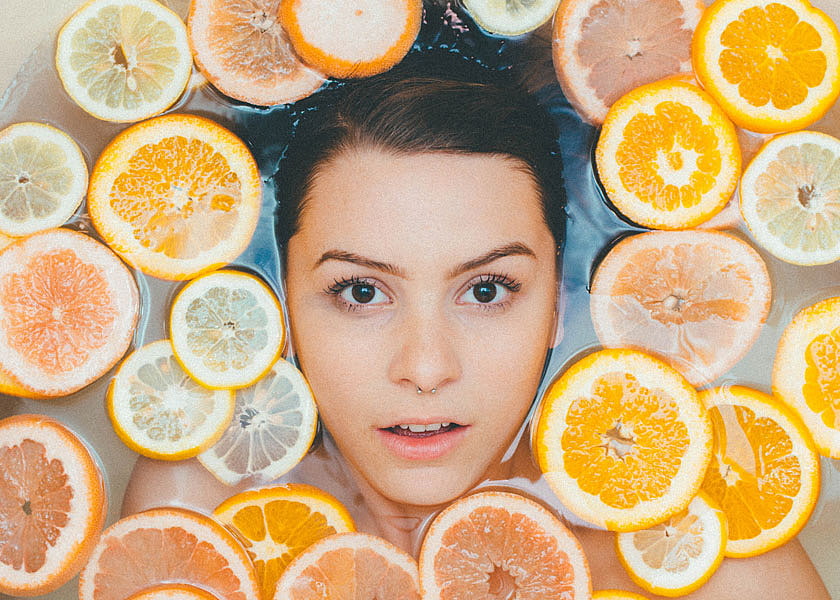 Girl in bath with orange slices.
