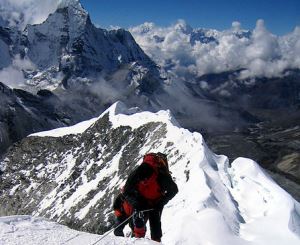 Image shows a mountaineer climbing a mountain.