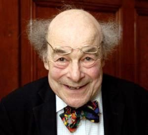 Image shows a mad professor-type with flyaway hair and a colourful bow tie.
