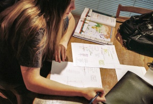 Image shows a school student doing homework.