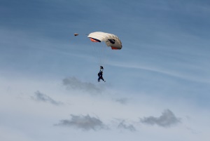 Image shows a man on a parachute.