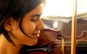 Image shows a woman playing the violin.