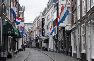 Image shows a street lined with Dutch flags.
