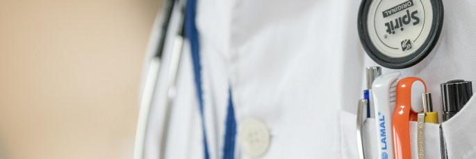 Image shows a doctor in a lab coat.