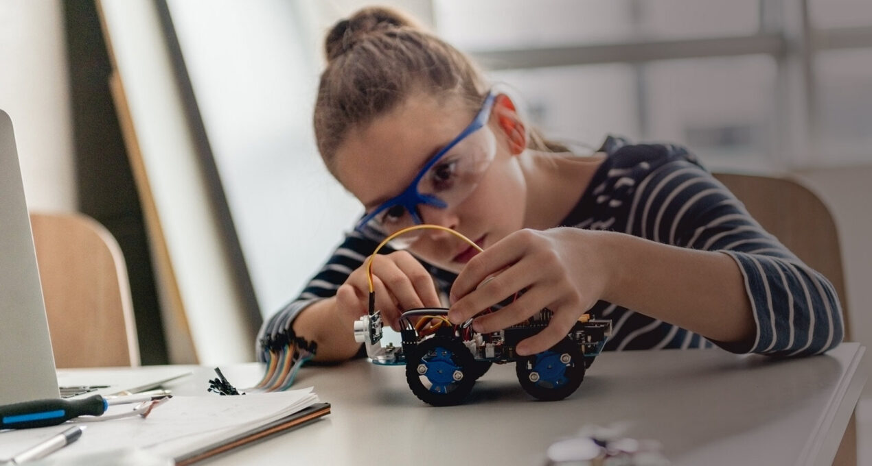 Student putting together a model car - Cambridge Engineering Summer School