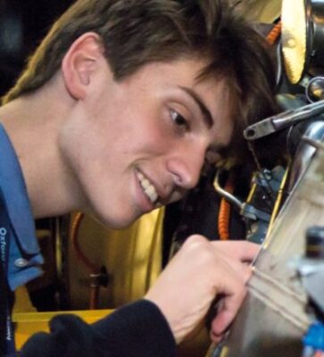 Student inspecting an engine at the Engineering Summer School hosted by Oxford Royale 2024/2025 [Mobile]